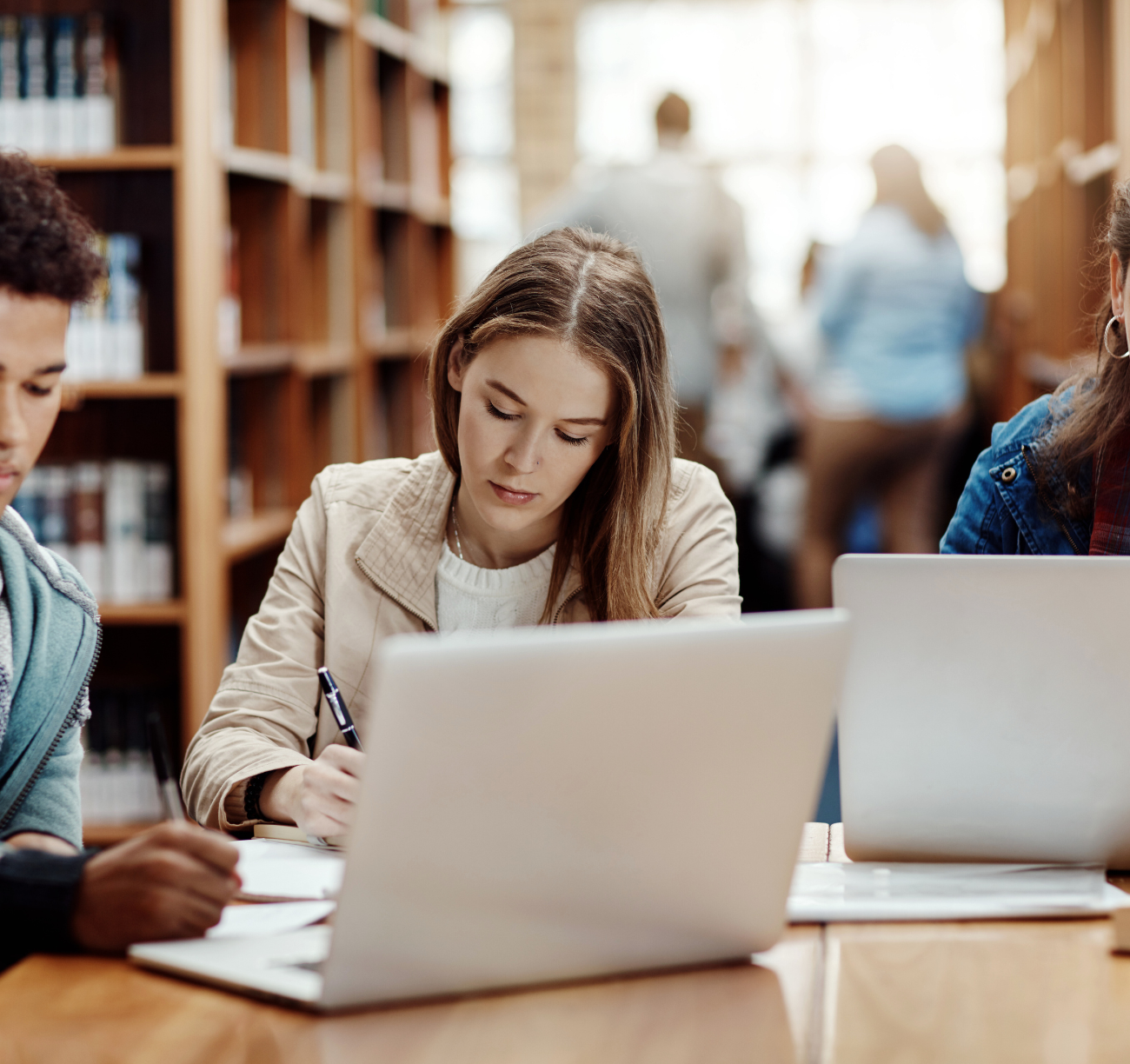 Young couple researching home loan options on laptop in a library setting